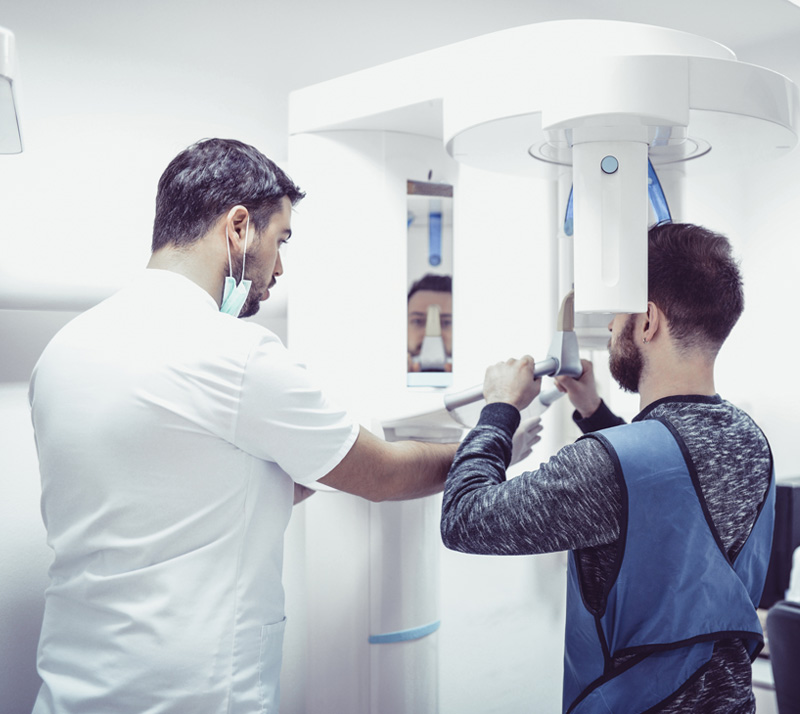 Dentist performing dental X-ray scan