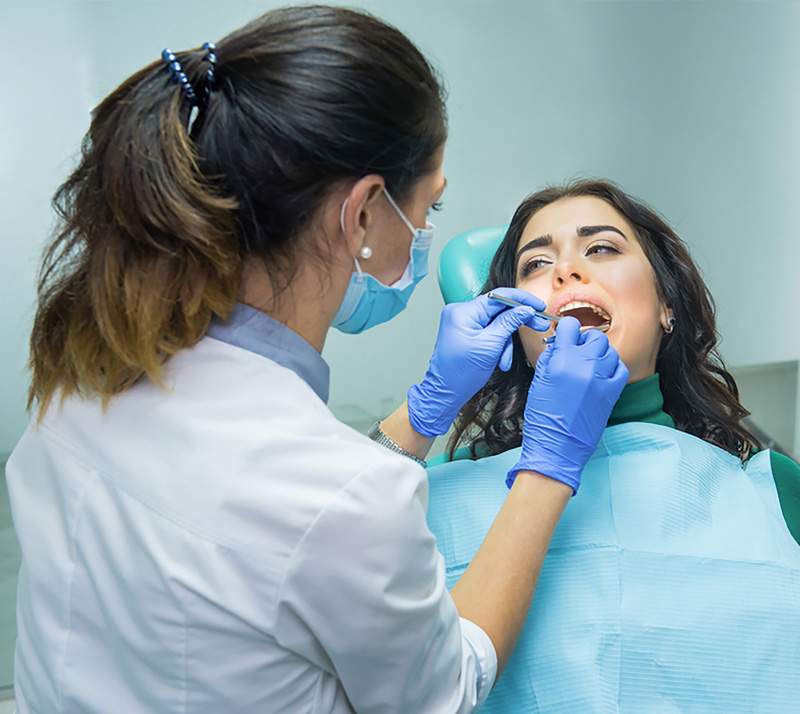 Dentist examining patient